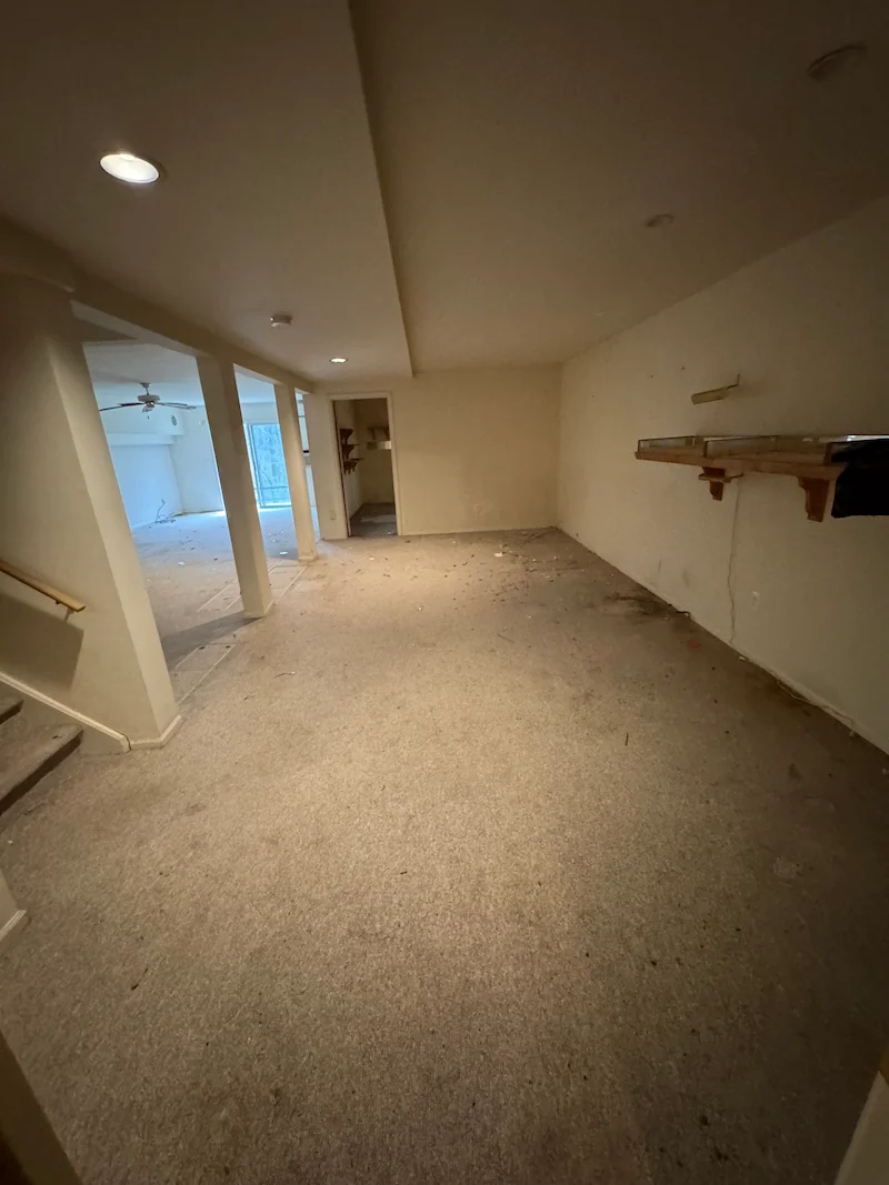 After photo of the same basement room completely cleared and empty after professional junk removal by JunkDoctors.
