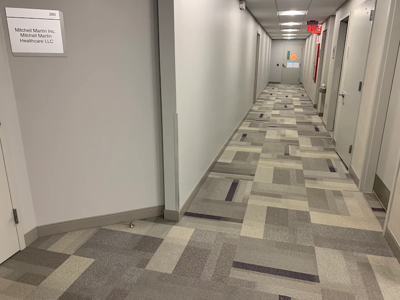 The same commercial office hallway now completely empty and swept following a professional JunkDoctors office cleanout in New Jersey.