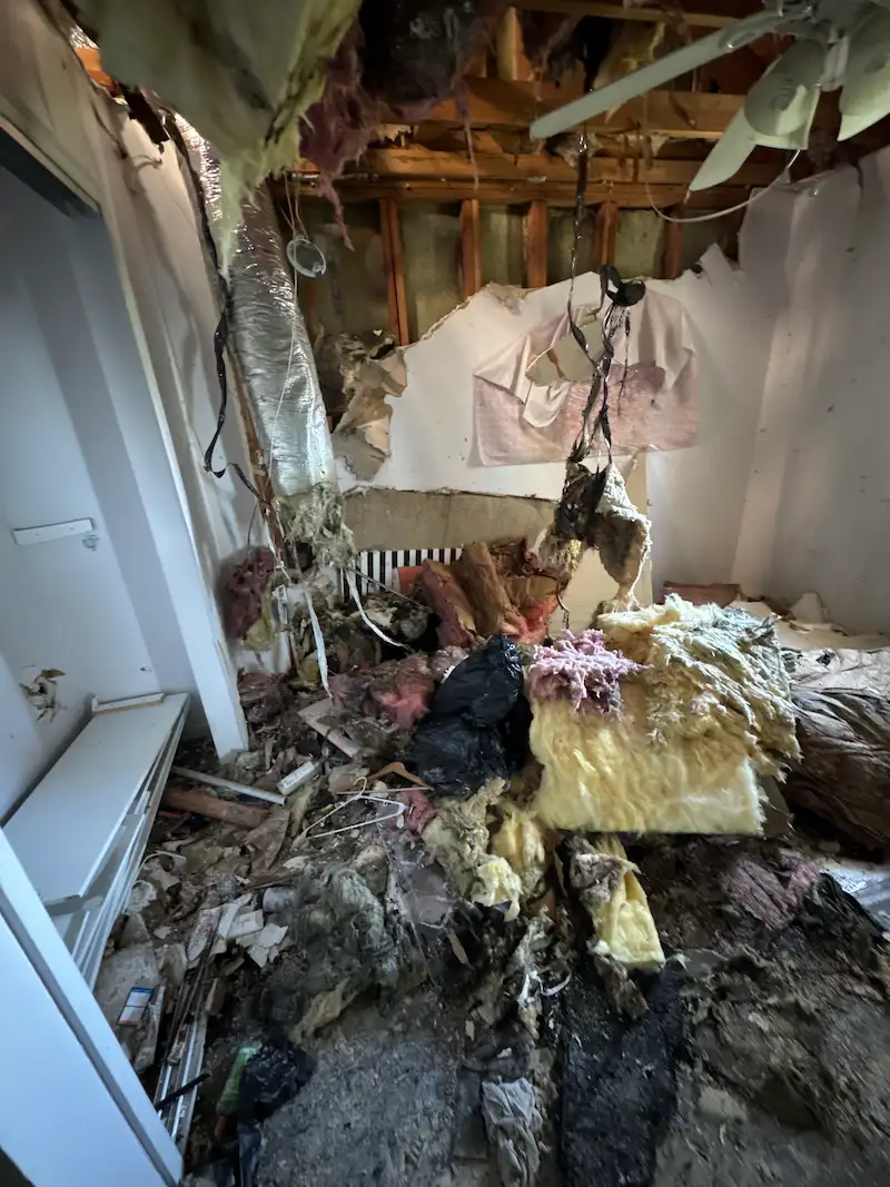 Before photo of a room filled with heavy structural construction waste like drywall and insulation before being cleared by Junk Doctors.