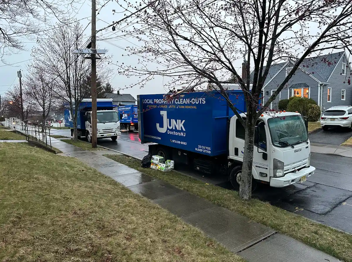 A fleet of JunkDoctors NJ trucks providing emergency flood cleanout and water damage debris removal for a residential neighborhood in North NJ.