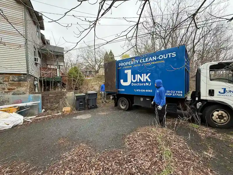 JunkDoctors 25-yard truck performing an REO foreclosure cleanout at a residential property in New Jersey.