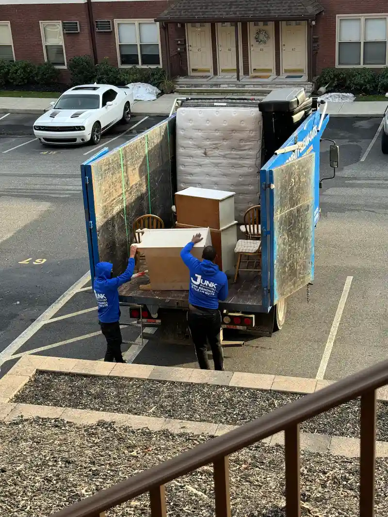 A fully loaded JunkDoctors 25-cubic-yard junk removal truck ready for haul-away after a residential pickup in New Jersey.