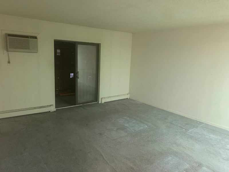 A completely empty and cleared apartment living room in Newton, NJ following a professional hoarding cleanup service by JunkDoctors.