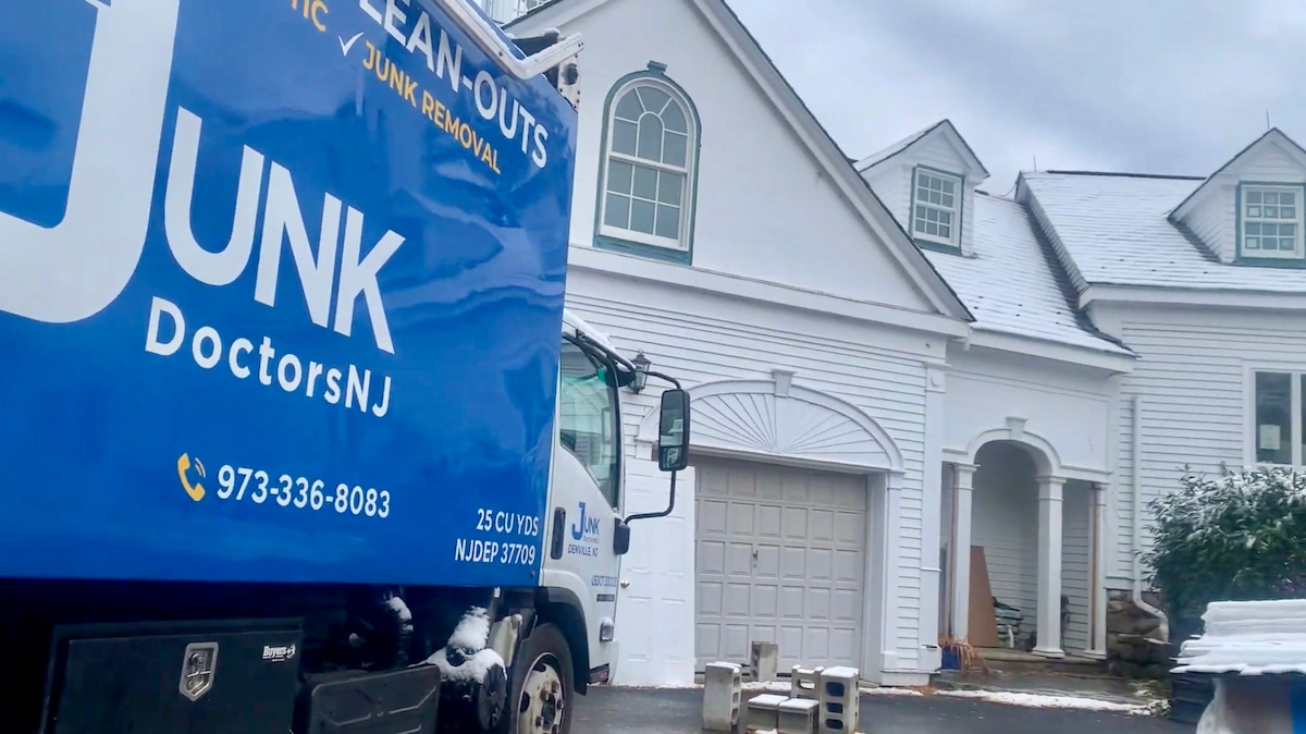 A licensed Junk DoctorsNJ construction debris removal truck parked at a residential job site in New Jersey, providing professional waste hauling services.