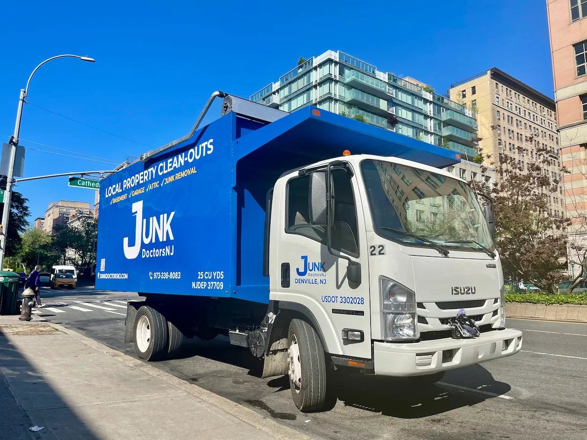 Side view of a JunkDoctors NJ commercial junk removal truck equipped for large-scale office and warehouse furniture disposal.