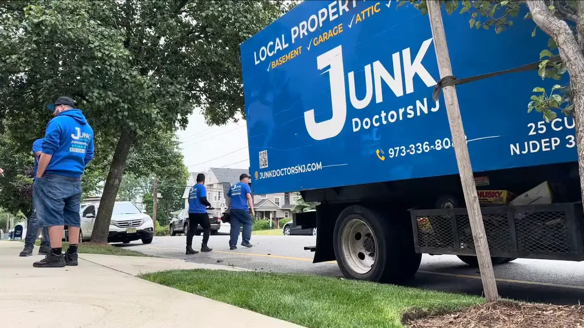 JunkDoctors NJ removal truck and uniformed crew arriving on a residential street for a local property cleanout service.