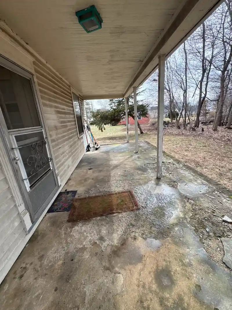 An empty, debris-free residential porch in NJ following a professional foreclosure property cleanout by JunkDoctors.