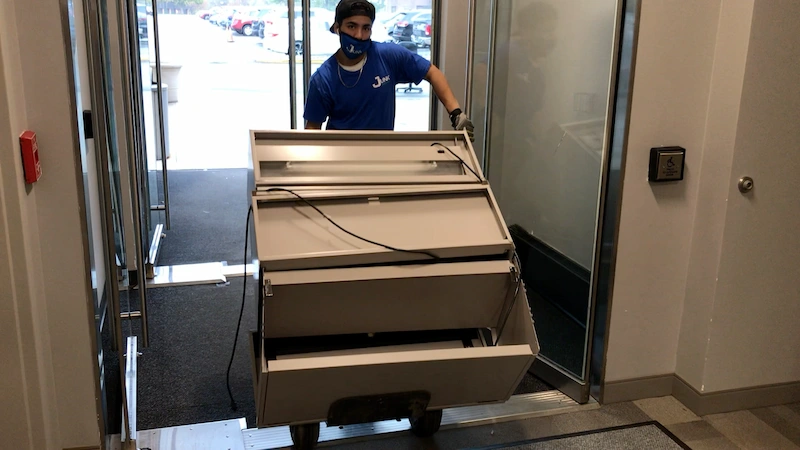Professional removal of a heavy metal storage cabinet from a New Jersey storage facility.