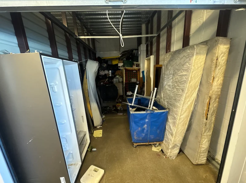 A messy rental storage unit in Woodbridge, New Jersey packed with items before a JunkDoctors cleanout.
