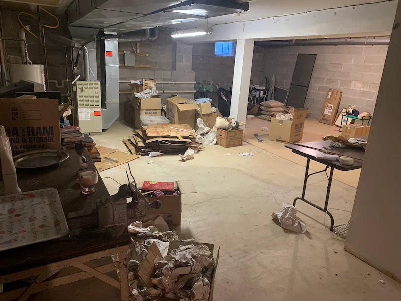 Basement with stored contents before an estate cleanout in New Jersey