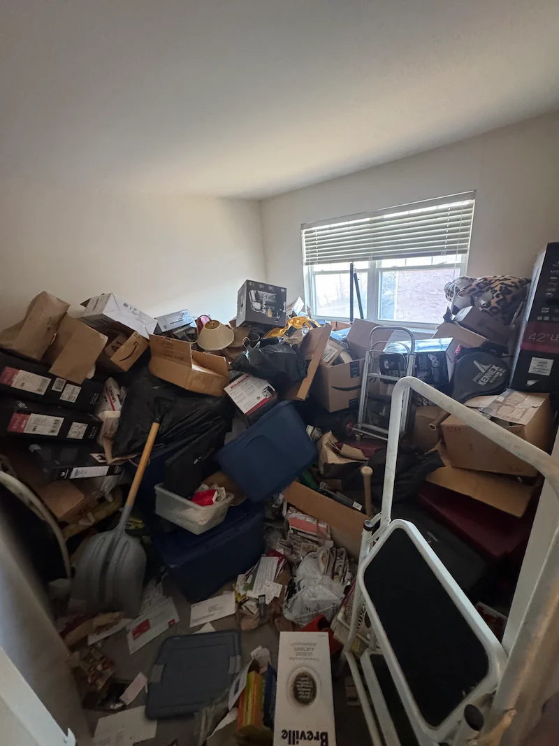 Living room with severe clutter before an extreme hoarding cleanout in New Jersey