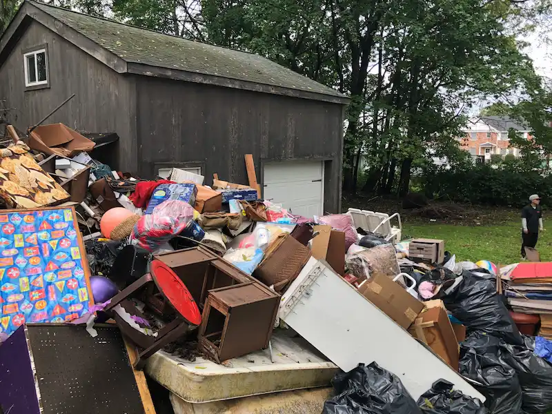 Exterior property with a large accumulation before a hoarding cleanout in New Jersey