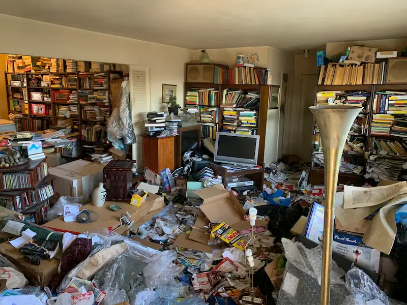 Cluttered room before a selective hoarding cleanup in New Jersey