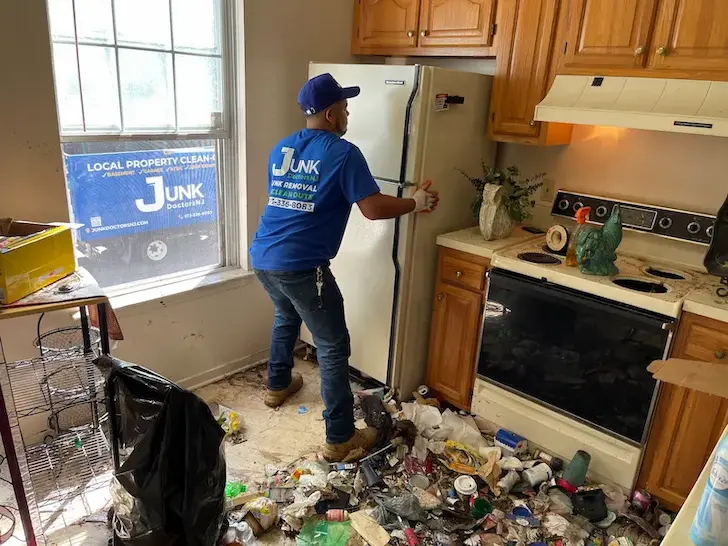Refrigerator being removed during a hoarding cleanout project in New Jersey.